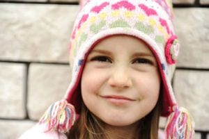 Adorable little girl with positive smiling face